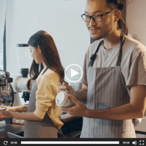 Two baristas working in coffee shop