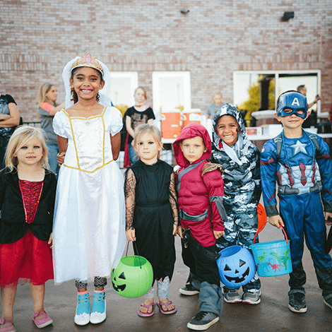 Kids of different ages dressed in Halloween costumes