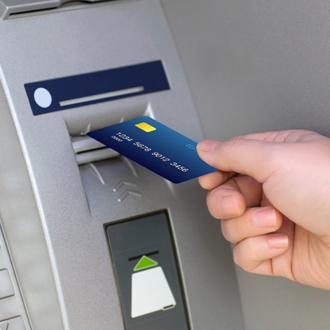 Person entering card into ATM