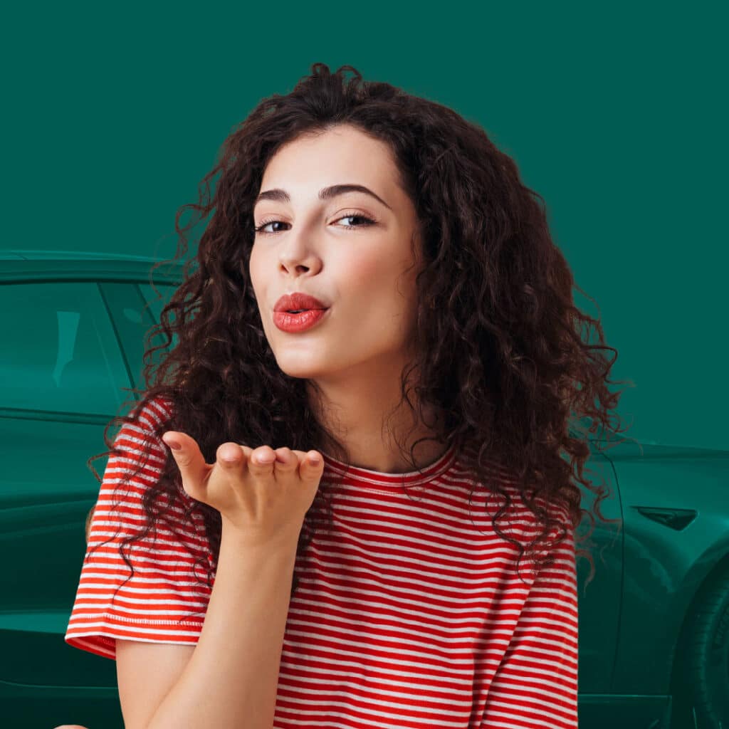 Woman blowing a kiss in front of a car silhouette, suggesting affection for a new vehicle